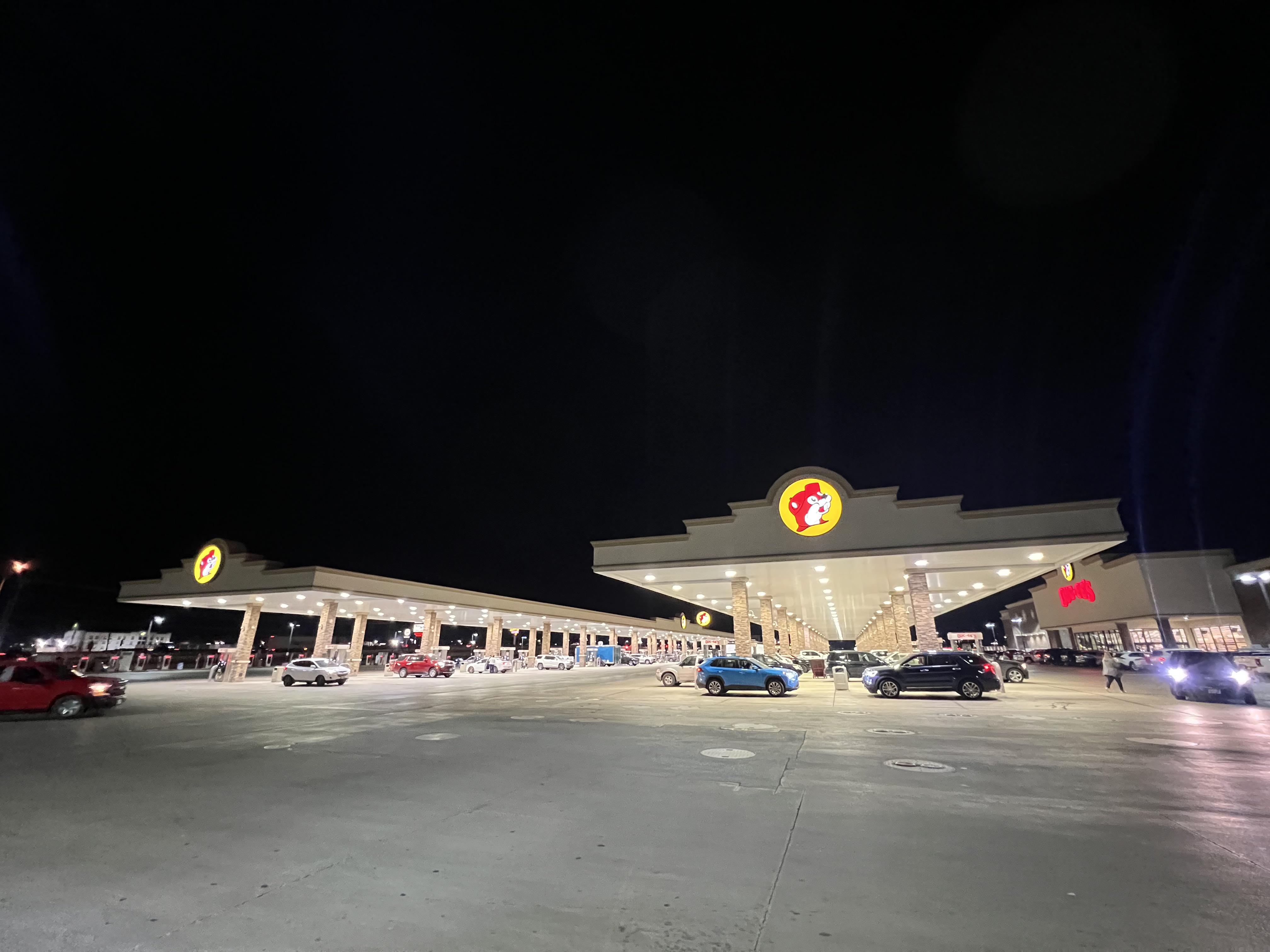 Low shot of Buc-ee's gas pump stations at night.